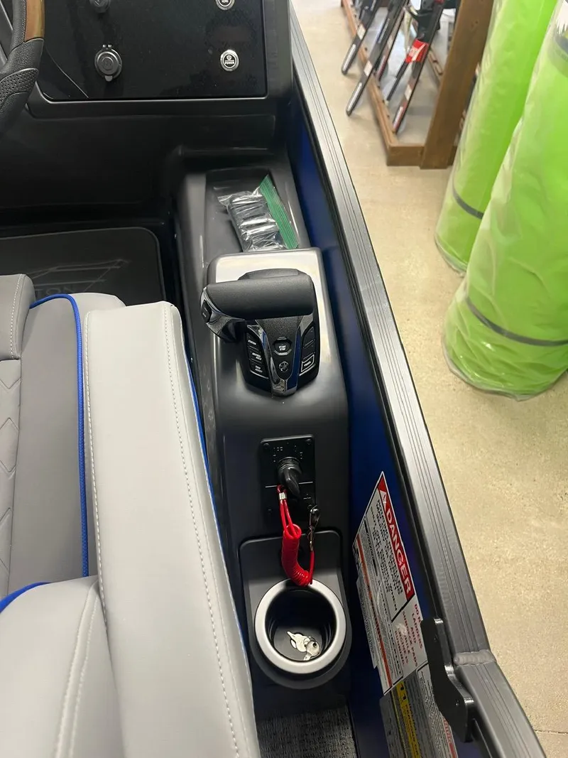 Slide: The Image of 2025 Bennington 24 MSB boat interior with control panel and cup holder. - 8