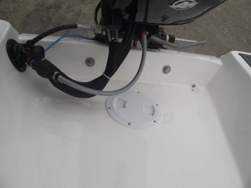 Slide: The Image of Bayliner Element M15 2025 boat engine compartment with visible hoses and fittings. - 23