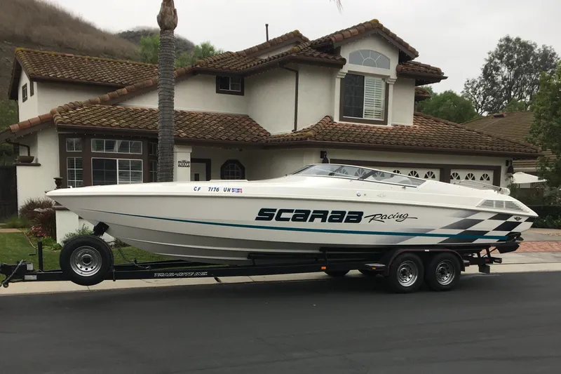 Slide: The Image of 1998 Wellcraft Scarab 30 boat on trailer in suburban neighborhood. - 3