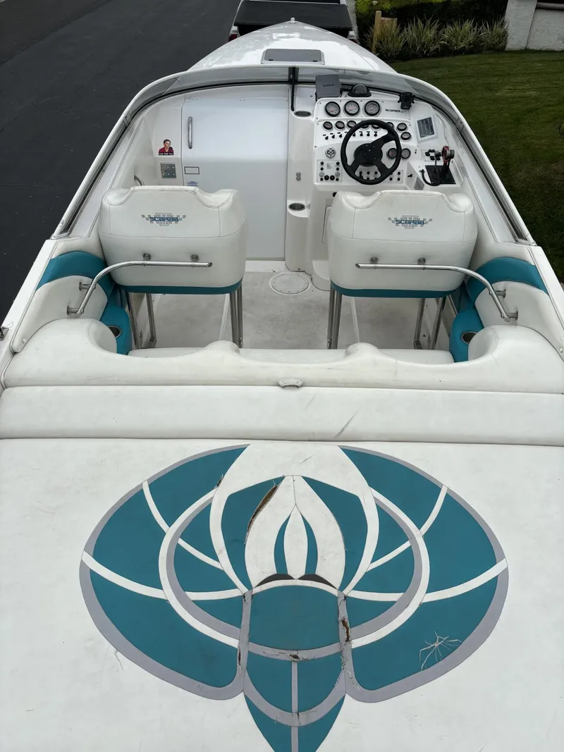 Slide: The Image of 1998 Wellcraft Scarab 30 boat interior with dual seats and steering console. - 4