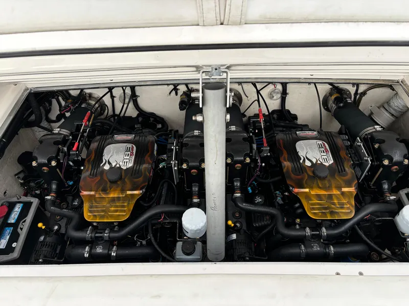 Slide: The Image of Twin engines of a 1998 Wellcraft Scarab 30 boat, showcasing detailed mechanics. - 7