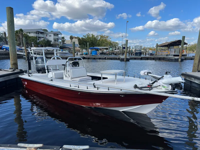 Slide: The Image of 2024 Deno 17 Flats boat docked in a marina under a blue sky. - 3