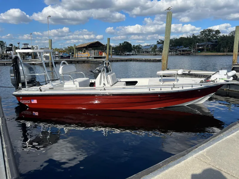 Slide: The Image of Red Deno 17 Flats boat docked on a sunny day, 2024 model. - 8