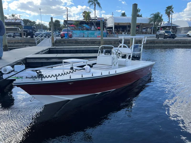 Slide: The Image of 2024 Deno 17 Flats boat docked at marina under blue sky. - 9