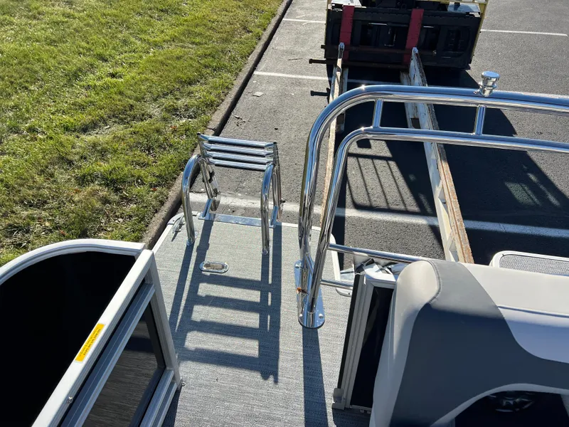 Slide: The Image of 2025 Godfrey Sweetwater 2286 C Special Edition boat, featuring sleek chrome details and a compact ladder. - 14