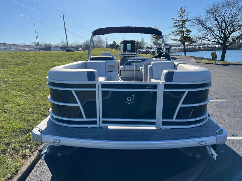 Slide: The Image of 2025 Godfrey Sweetwater 2286 C Special Edition pontoon boat parked near a lake. - 2