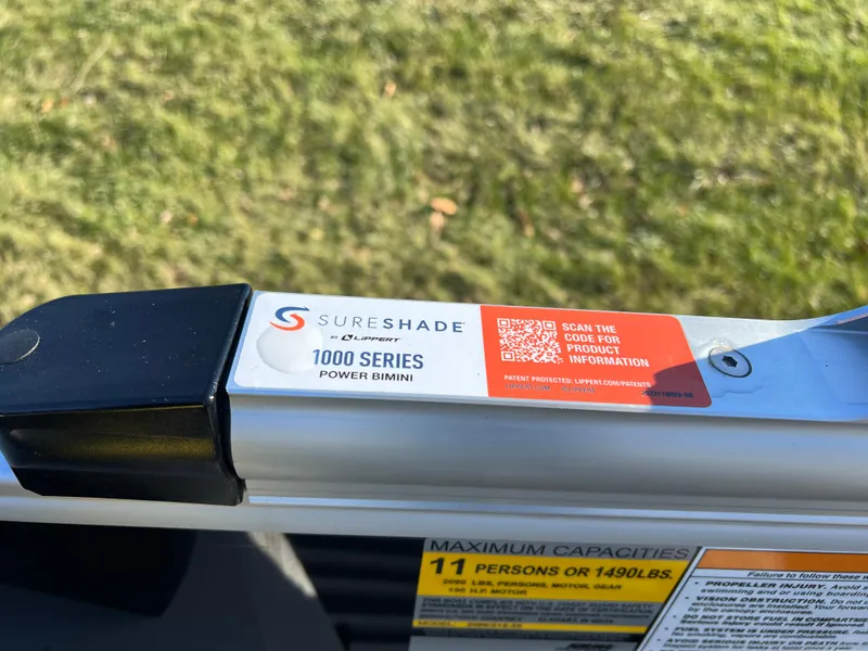 Slide: The Image of SureShade 1000 Series Power Bimini on 2025 Godfrey Sweetwater 2286 C Special Edition boat. - 21