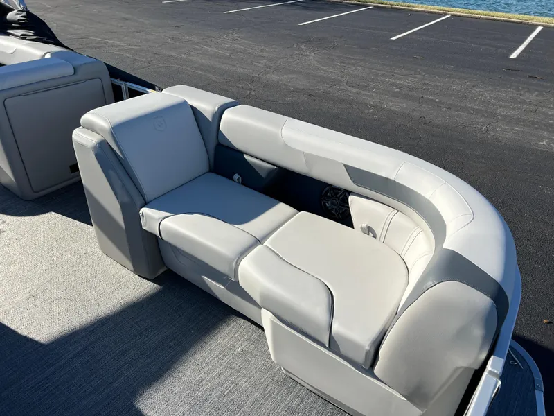 Slide: The Image of 2025 Godfrey Sweetwater 2286 C Special Edition boat seating, gray upholstery, outdoor setting. - 7