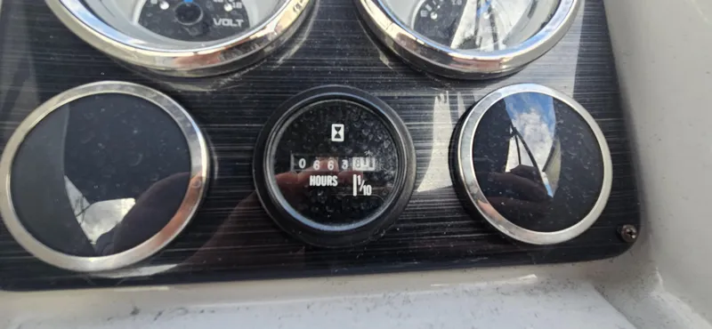 Slide: The Image of Dashboard of 2023 Sylvan Mirage X3 Tritoon showing engine hours. - 10