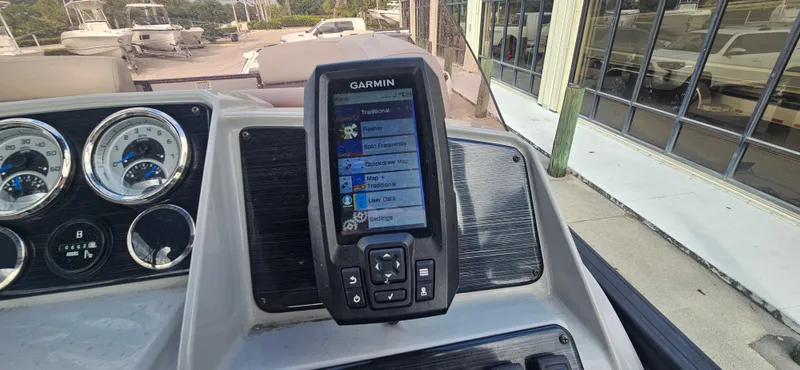 Slide: The Image of Garmin navigation system on 2023 Sylvan Mirage X3 Tritoon dashboard with gauges. - 12