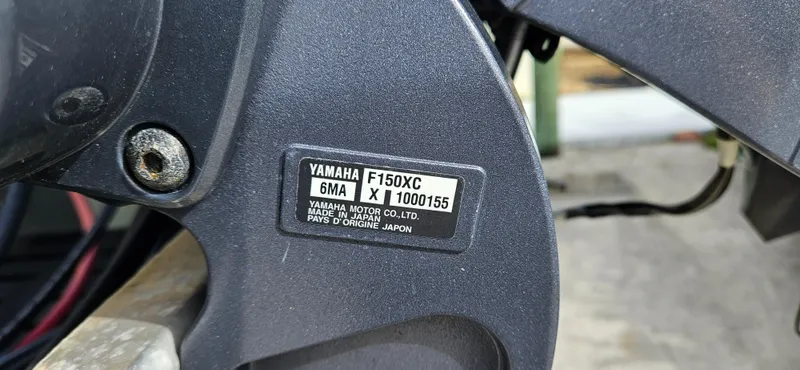 Slide: The Image of Close-up of Yamaha F150XC engine label on 2023 Sylvan Mirage X3 Tritoon. - 18
