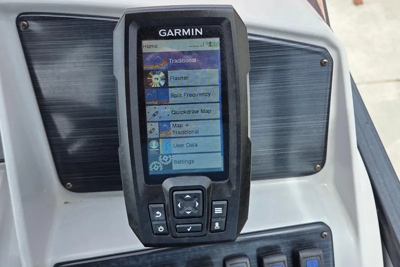 Slide: The Image of Garmin device on 2023 Sylvan Mirage X3 Tritoon dashboard displaying navigation options. - 19
