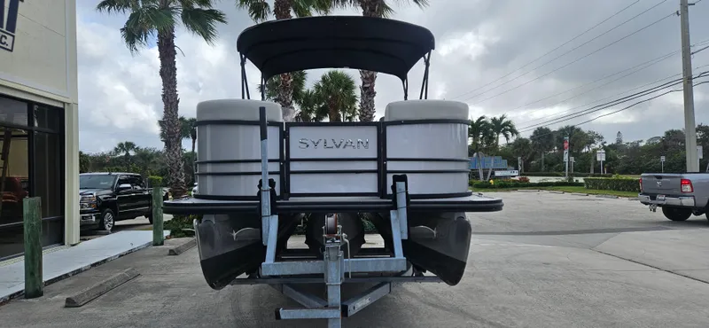 Slide: The Image of 2023 Sylvan Mirage X3 Tritoon boat on trailer, parked outdoors. - 3