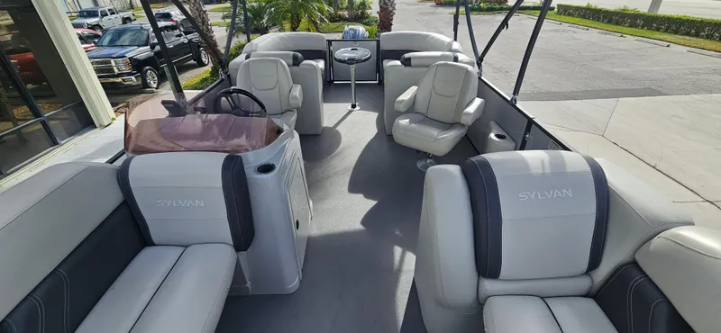 Slide: The Image of 2023 Sylvan Mirage X3 Tritoon interior with luxurious seating and modern design. - 5