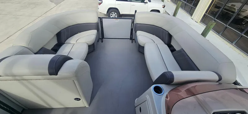 Slide: The Image of 2023 Sylvan Mirage X3 Tritoon interior with spacious seating and modern design. - 7