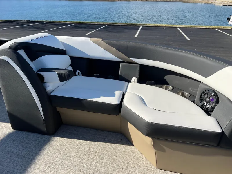 Slide: The Image of 2025 South Bay 222 RS boat interior with plush seating by the water. - 11
