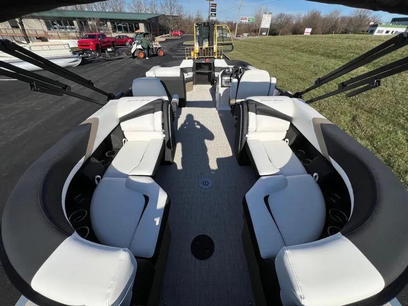 Slide: The Image of 2025 South Bay 222 RS pontoon boat interior with white seating and spacious layout. - 16