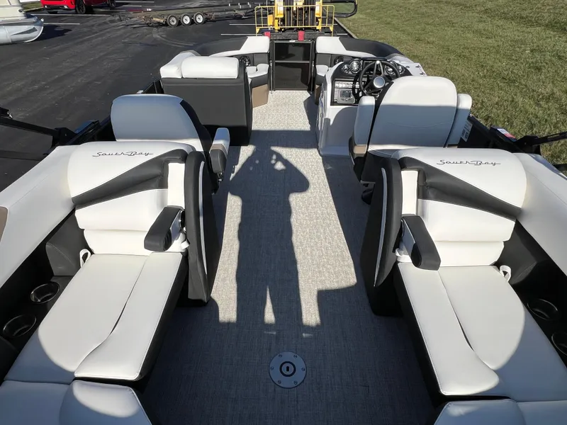 Slide: The Image of 2025 South Bay 222 RS pontoon boat interior with white seating and modern dashboard. - 19