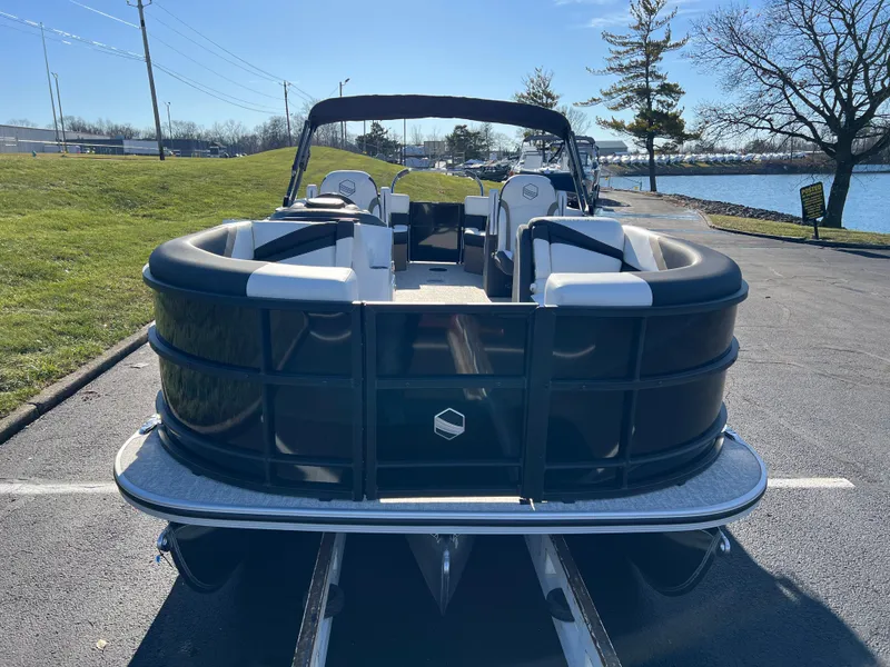 Slide: The Image of 2025 South Bay 222 RS pontoon boat parked near a lake on a sunny day. - 2
