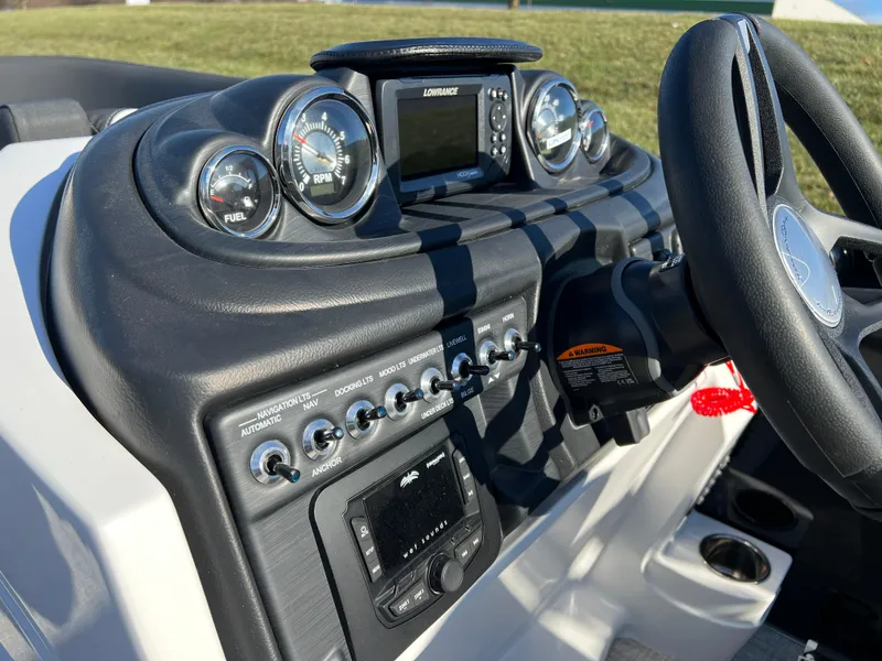 Slide: The Image of 2025 South Bay 222 RS boat dashboard with gauges and controls. - 23