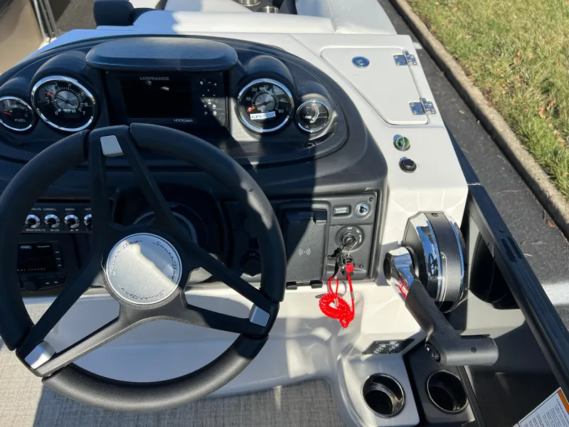 Slide: The Image of 2025 South Bay 222 RS boat dashboard with steering wheel and controls. - 24