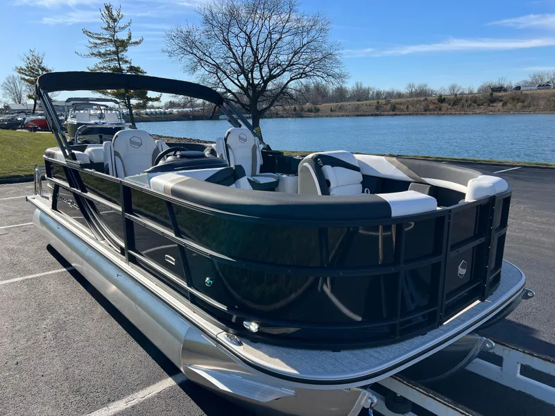 Slide: The Image of 2025 South Bay 222 RS pontoon boat parked by a serene lake. - 3