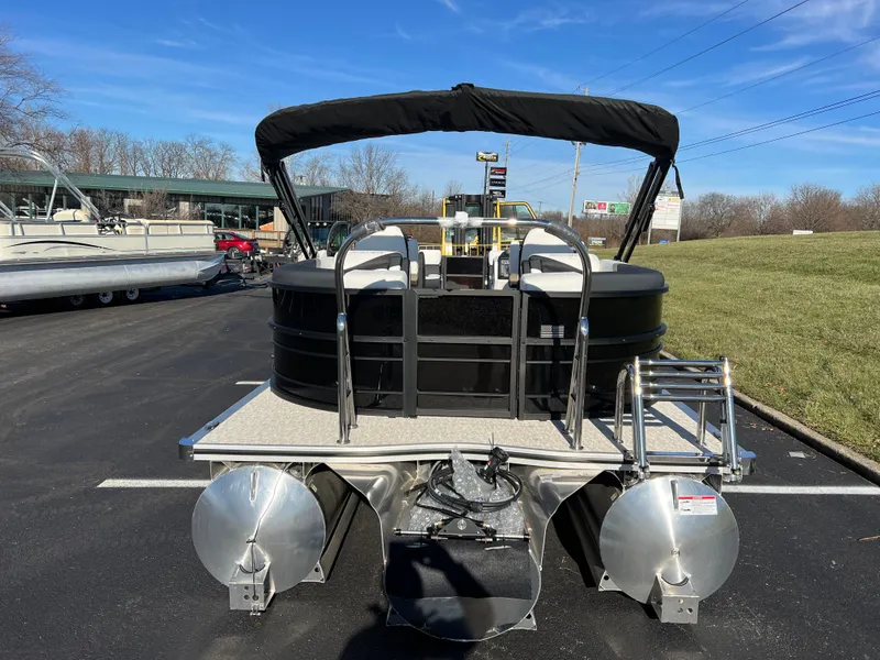 Slide: The Image of 2025 South Bay 222 RS pontoon boat with black canopy, parked on asphalt. - 6
