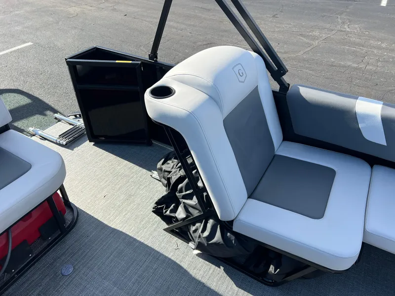 Slide: The Image of 2025 Godfrey Mighty G 1476 C boat interior with cushioned seating and storage. - 11