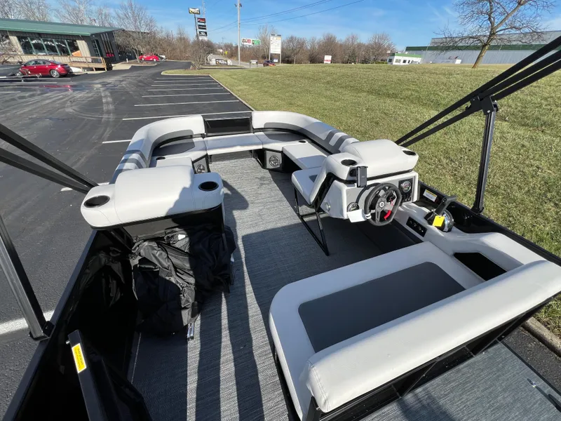 Slide: The Image of 2025 Godfrey Mighty G 1476 C pontoon boat interior with seating and steering console. - 13