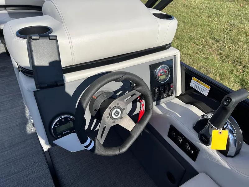 Slide: The Image of 2025 Godfrey Mighty G 1476 C boat dashboard with steering wheel and controls. - 15