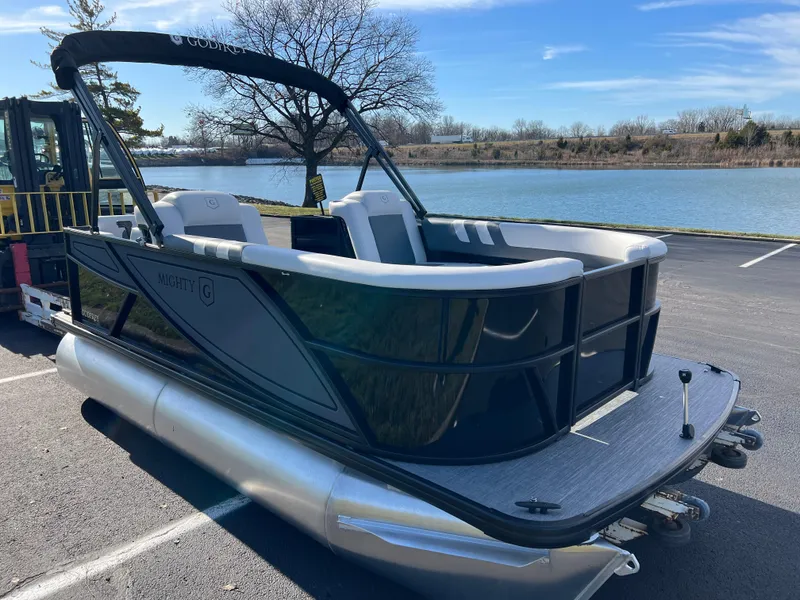 Slide: The Image of 2025 Godfrey Mighty G 1476 C pontoon boat by a serene lake. - 3