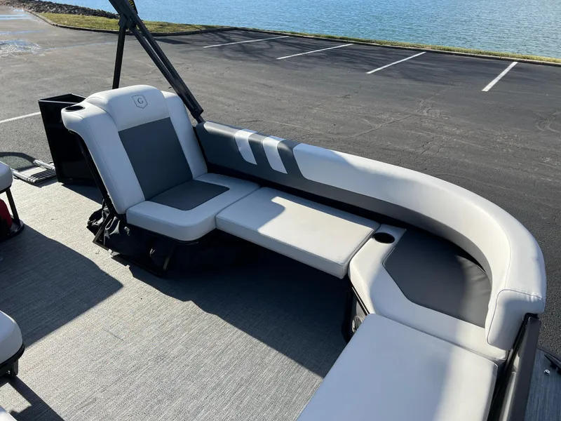 Slide: The Image of 2025 Godfrey Mighty G 1476 C pontoon boat with gray seating by the water. - 8