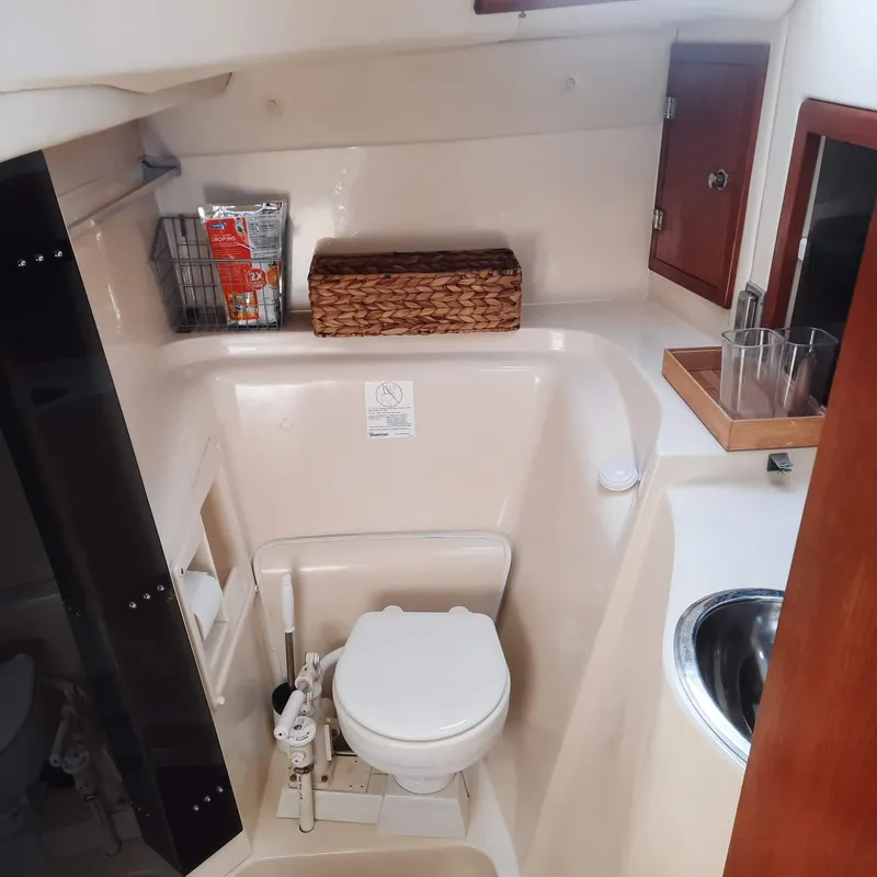 Slide: The Image of 2006 Gemini 105 MC boat bathroom with toilet, sink, and storage. - 11