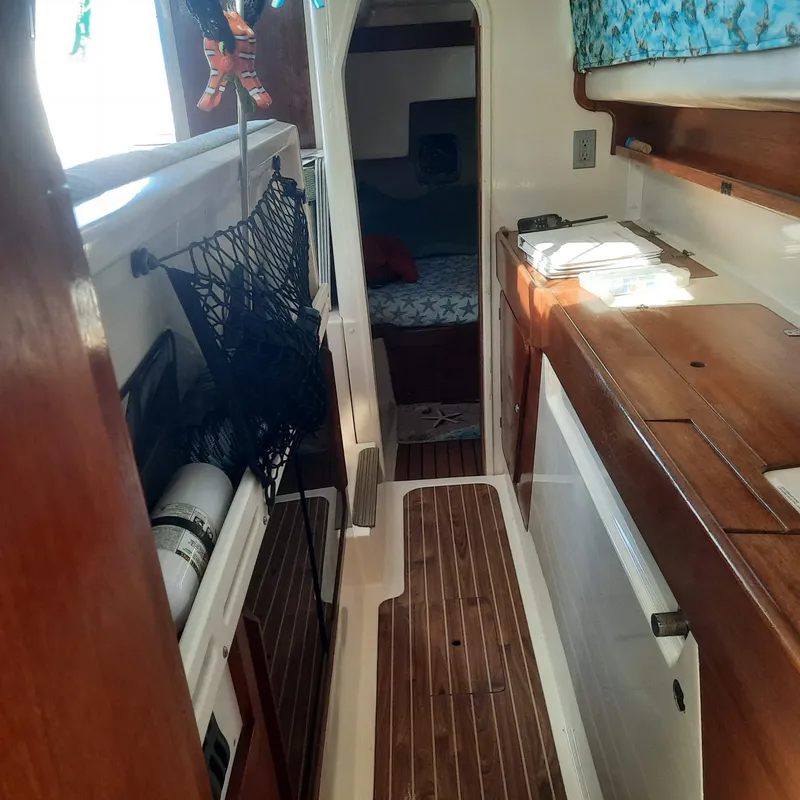 Slide: The Image of Interior of 2006 Gemini 105 MC sailboat with wood accents and cozy cabin space. - 12
