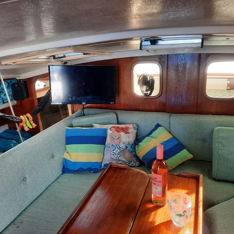 Slide: The Image of Cozy interior of 2006 Gemini 105 MC catamaran with colorful cushions and a TV. - 15