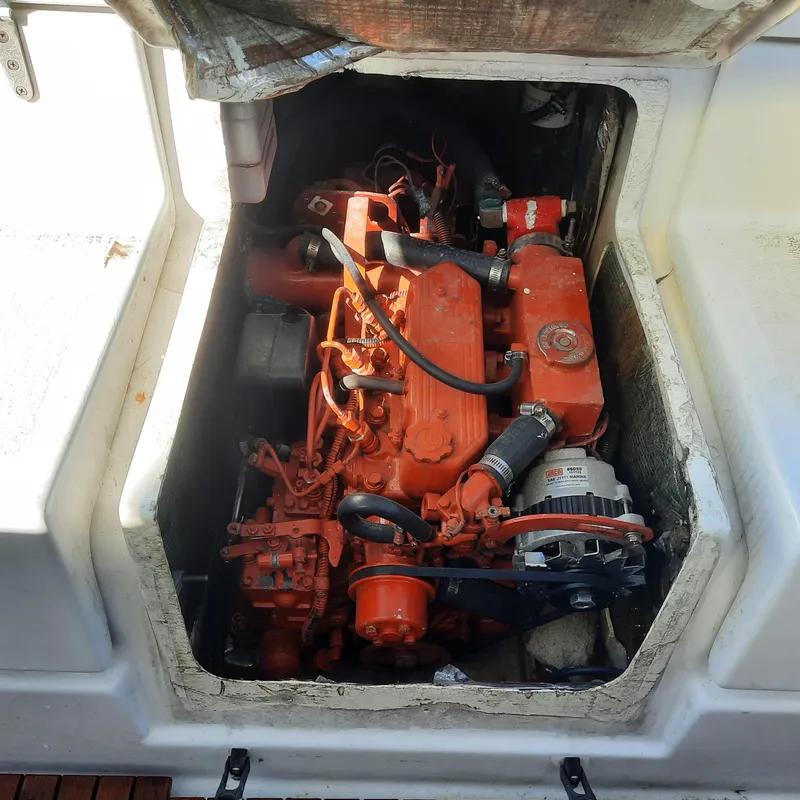 Slide: The Image of 2006 Gemini 105 MC boat engine compartment with visible orange engine components. - 17