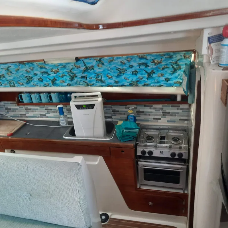 Slide: The Image of 2006 Gemini 105 MC yacht kitchen with stove, sink, and colorful decor. - 5