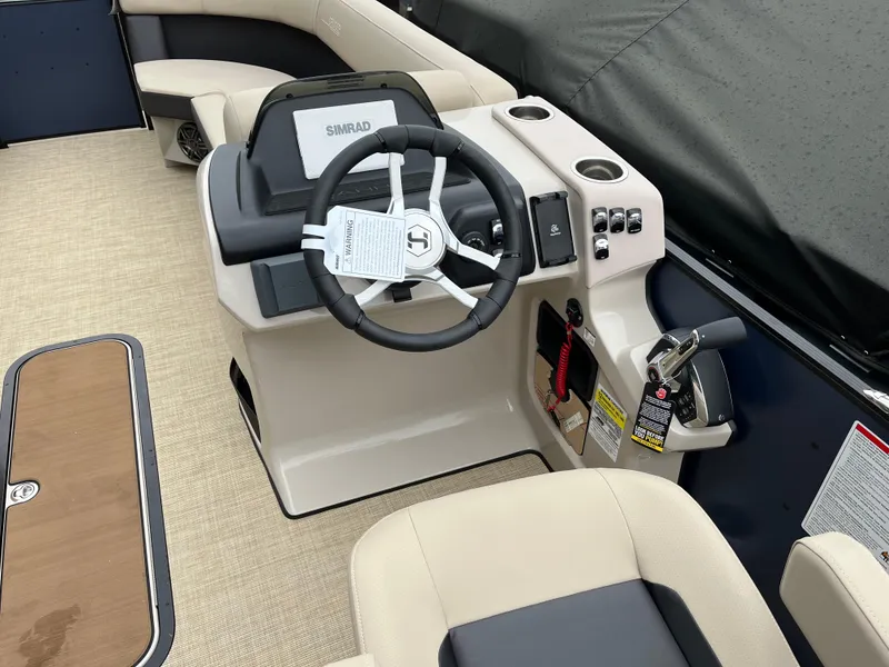 Slide: The Image of 2025 Harris Cruiser 230 boat interior with steering wheel and seating. - 11