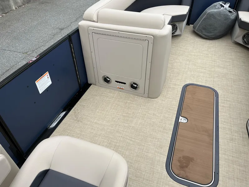 Slide: The Image of Interior of 2025 Harris Cruiser 230 boat with beige seating and carpeted floor. - 13