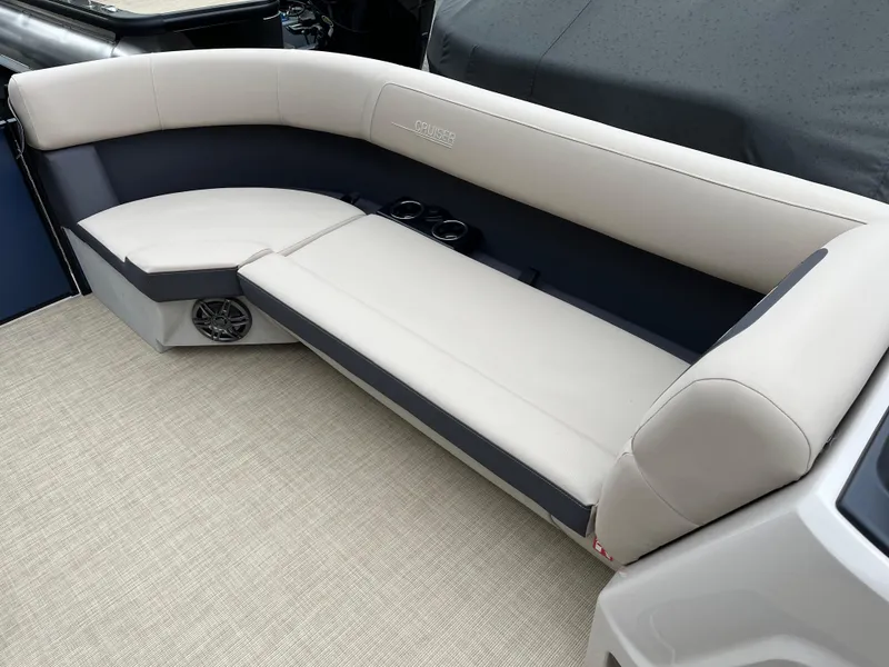 Slide: The Image of 2025 Harris Cruiser 230 boat interior with beige seating and cup holders. - 14