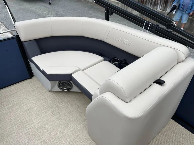 Slide: The Image of 2025 Harris Cruiser 230 boat interior with plush seating and speaker system. - 15