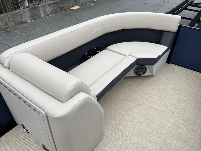 Slide: The Image of 2025 Harris Cruiser 230 boat interior with beige seating and cup holders. - 16