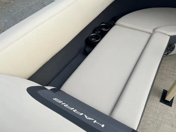 Slide: The Image of 2025 Harris Cruiser 230 boat interior with beige seating and cup holders. - 17