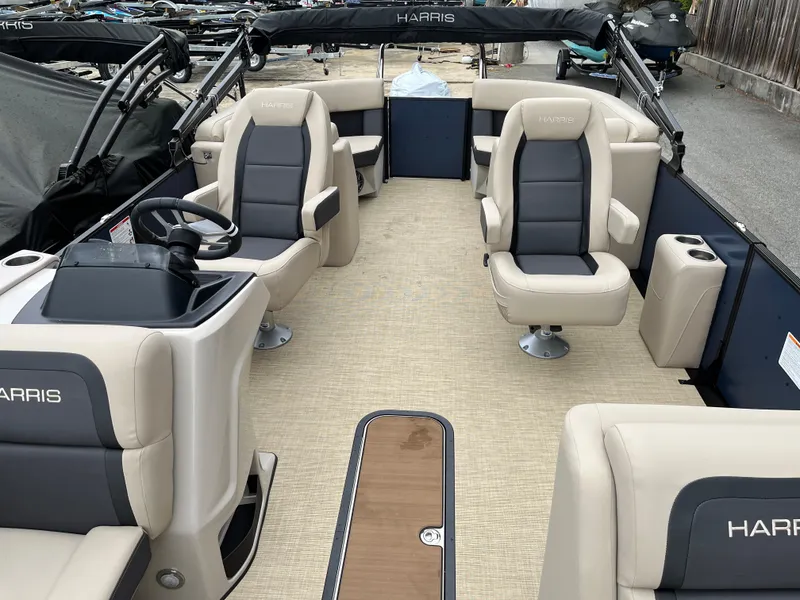 Slide: The Image of 2025 Harris Cruiser 230 pontoon boat interior with beige and gray seating. - 6