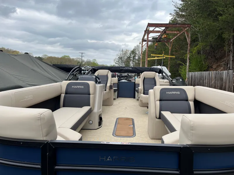 Slide: The Image of 2025 Harris Cruiser 230 pontoon boat with spacious seating and modern design. - 7