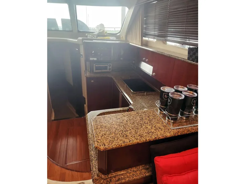 Slide: The Image of 2007 Sea Ray 52 Sedan Bridge yacht interior with granite countertops and wooden flooring. - 10