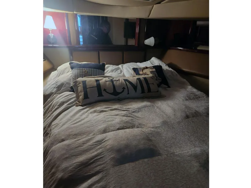 Slide: The Image of Cozy bedroom in 2007 Sea Ray 52 Sedan Bridge yacht with nautical-themed pillows. - 14