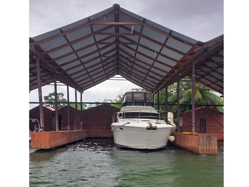 Slide: The Image of 2007 Sea Ray 52 Sedan Bridge docked under a covered marina. - 2