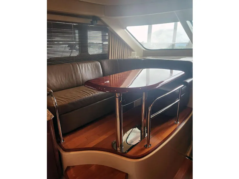 Slide: The Image of Luxurious interior of 2007 Sea Ray 52 Sedan Bridge yacht with leather seating and polished table. - 9