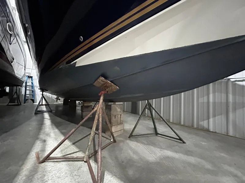 Slide: The Image of 2002 Fountain 38 Express Cruiser in storage, supported by stands. - 10